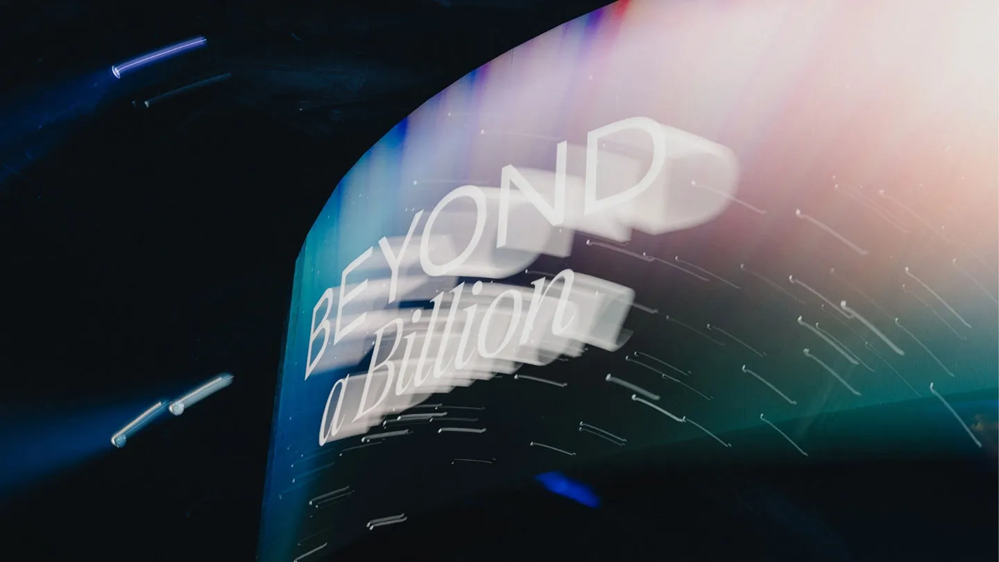 Beyond a Billion — handwritten title card on the curved arena LED canopy