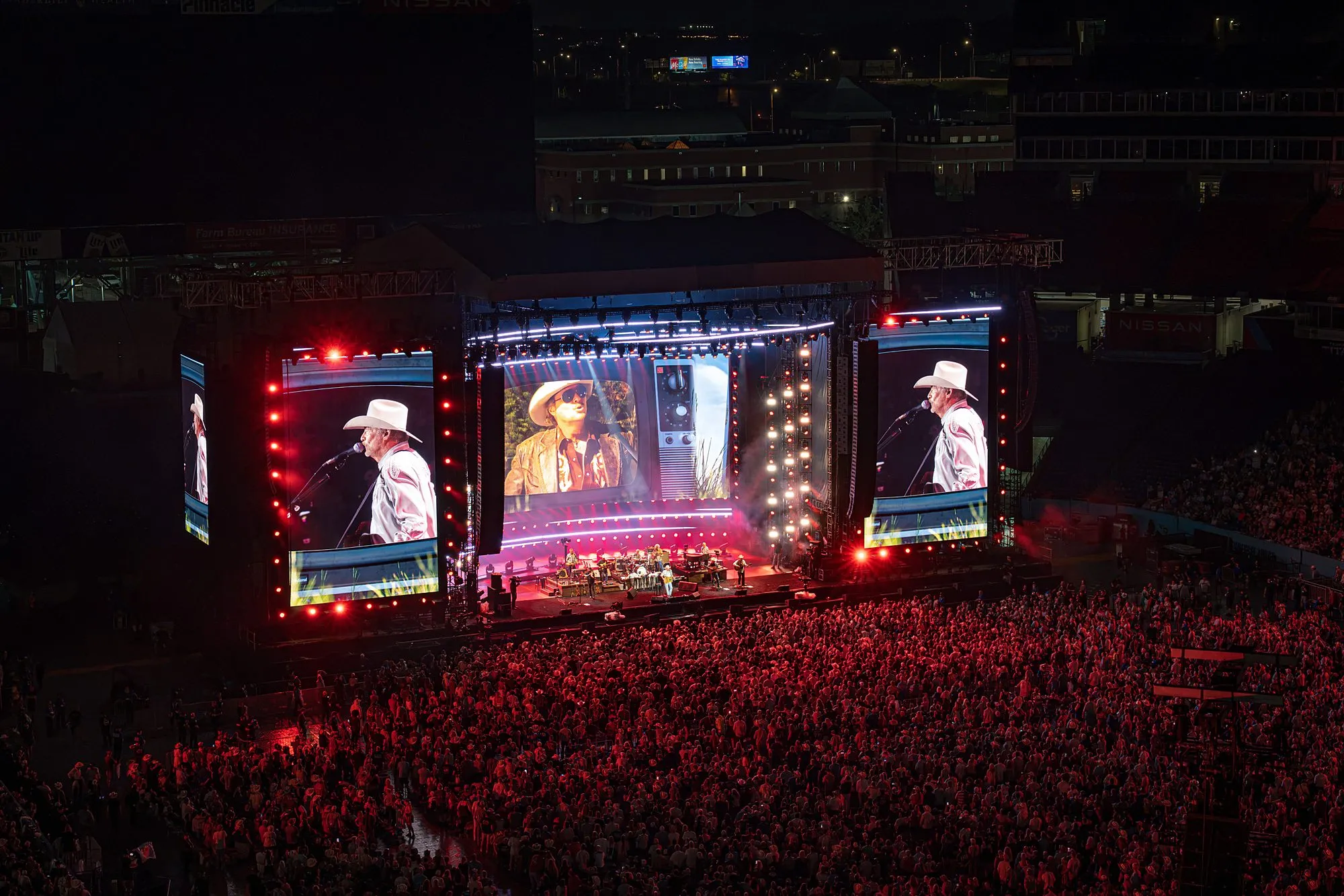 Vintage TV-set treatment on the center stadium screen with red-washed crowd, Nissan Stadium