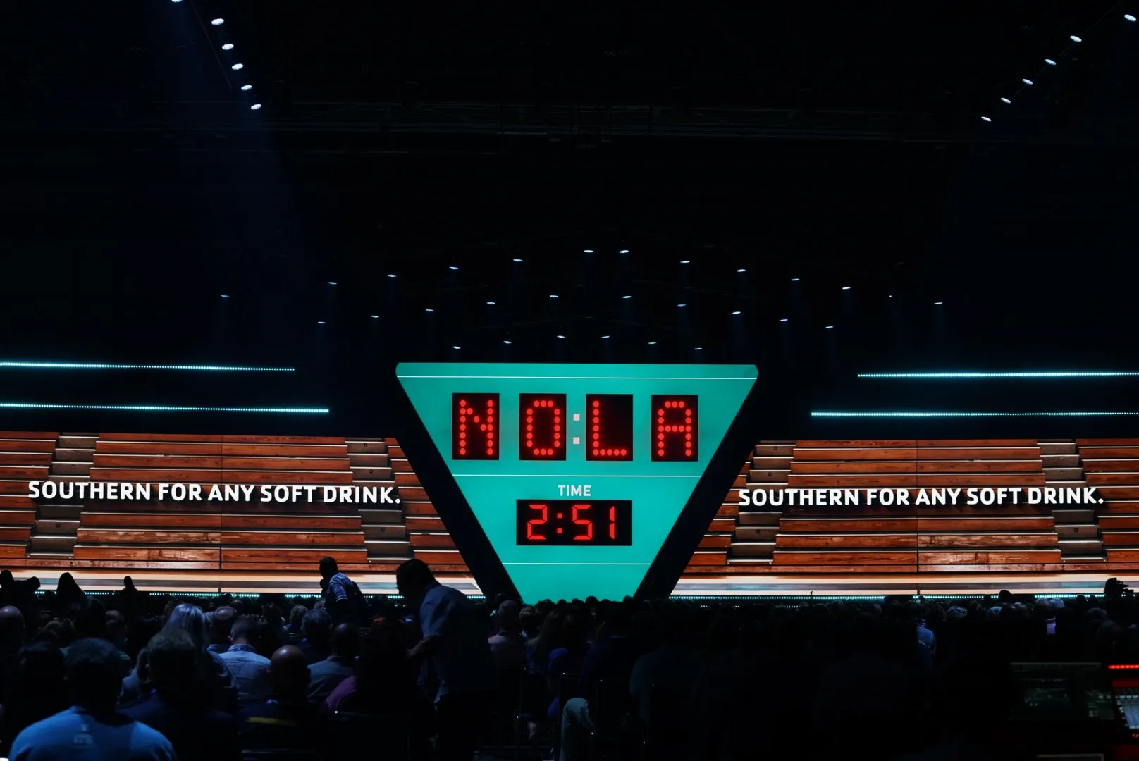 Trivia game on the LED — a red-dot NOLA scoreboard and clock on the center screen, with 'Southern for any soft drink.' across the wings